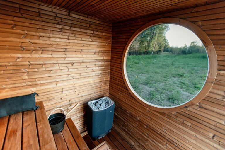 Interior of a wooden sauna with a round window.